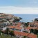 Rooftops on a hillside over a crescent shaped cove